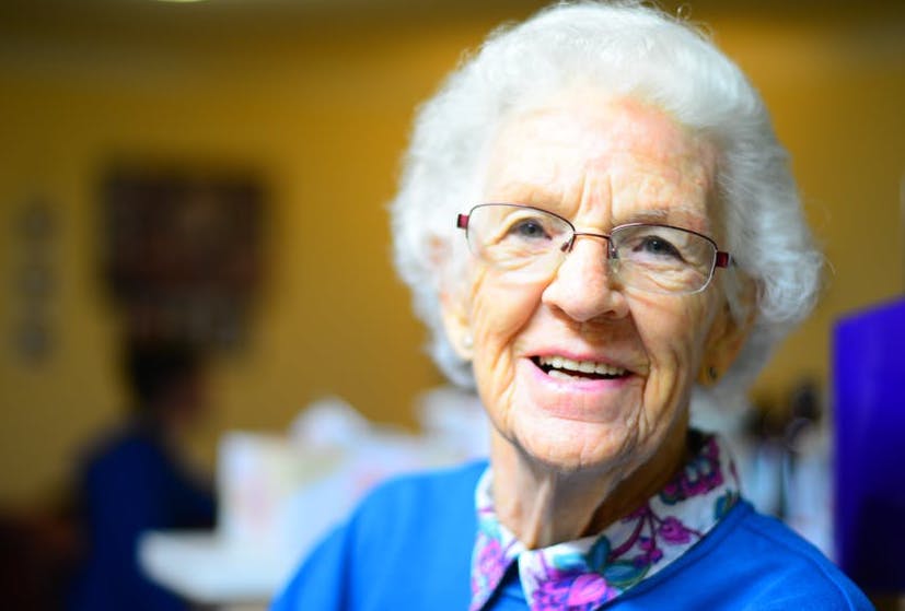 Elderly lady with grey hair and glasses